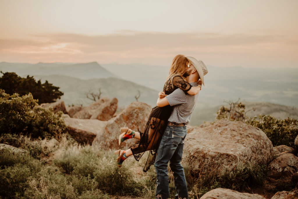 couple kissing on tip of the mountains at their oklahoma elopement
