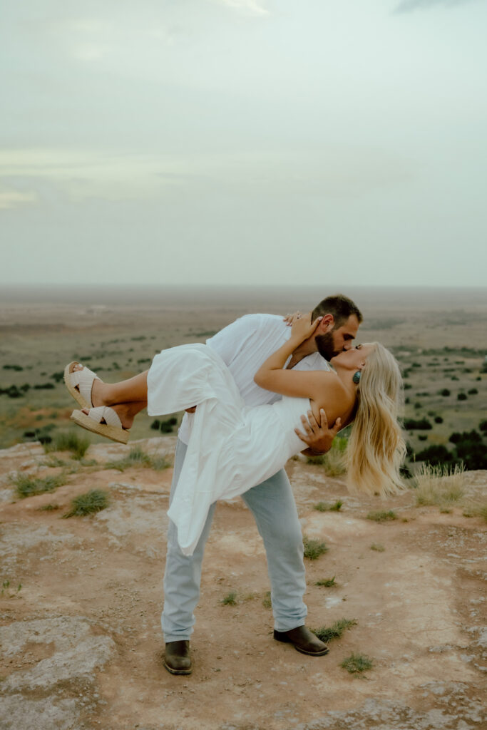 couple dip kisses at oklahoma elopement at gloss mountains