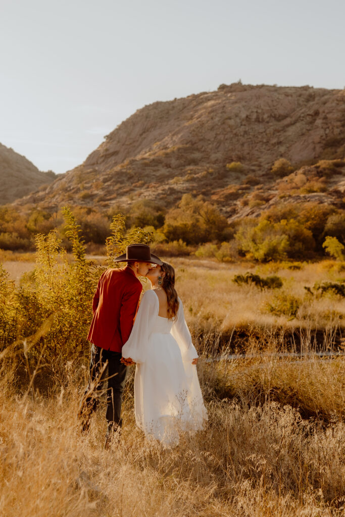 bride and groom kissing at their elopement in the mountains of oklahoma
