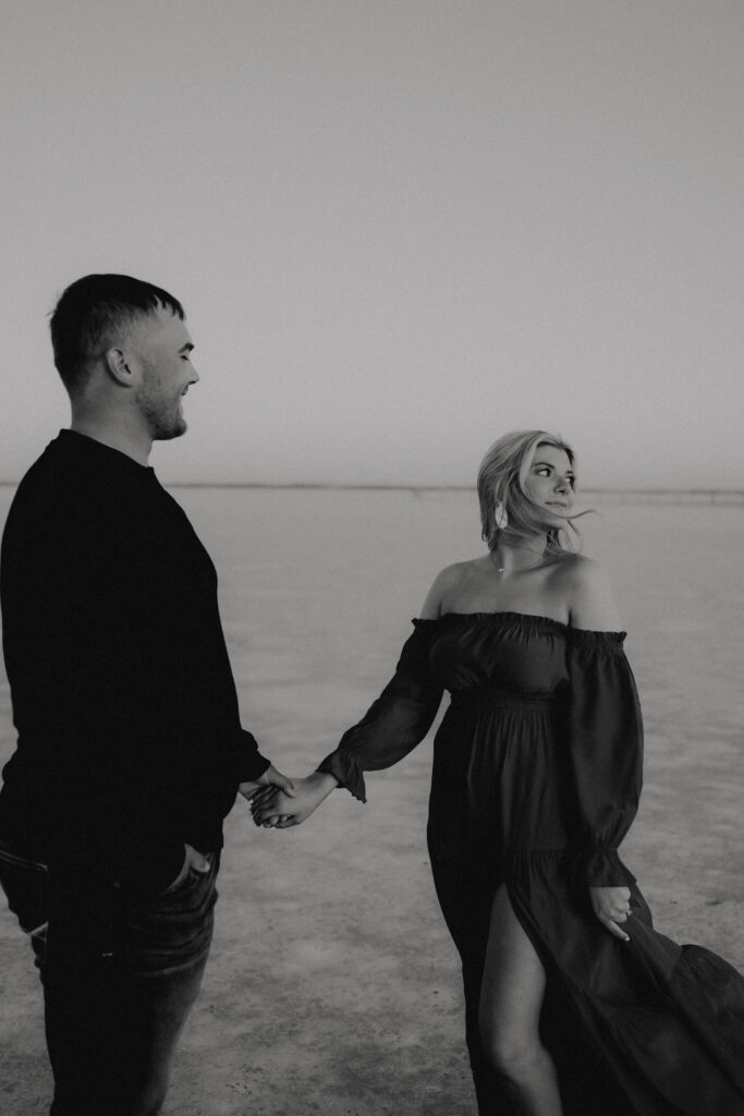 Engaged couple on the wide-open salt flats of Oklahoma at sunset