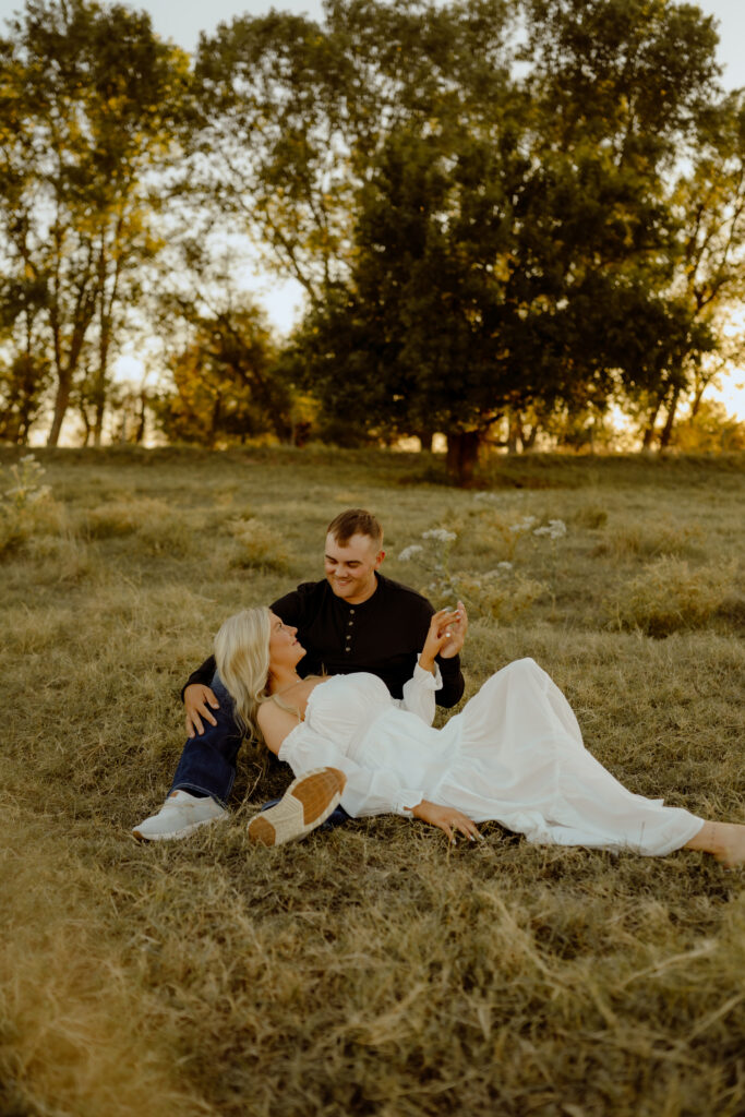 Romantic, windswept couples photo in the Oklahoma countryside, capturing a Western love story