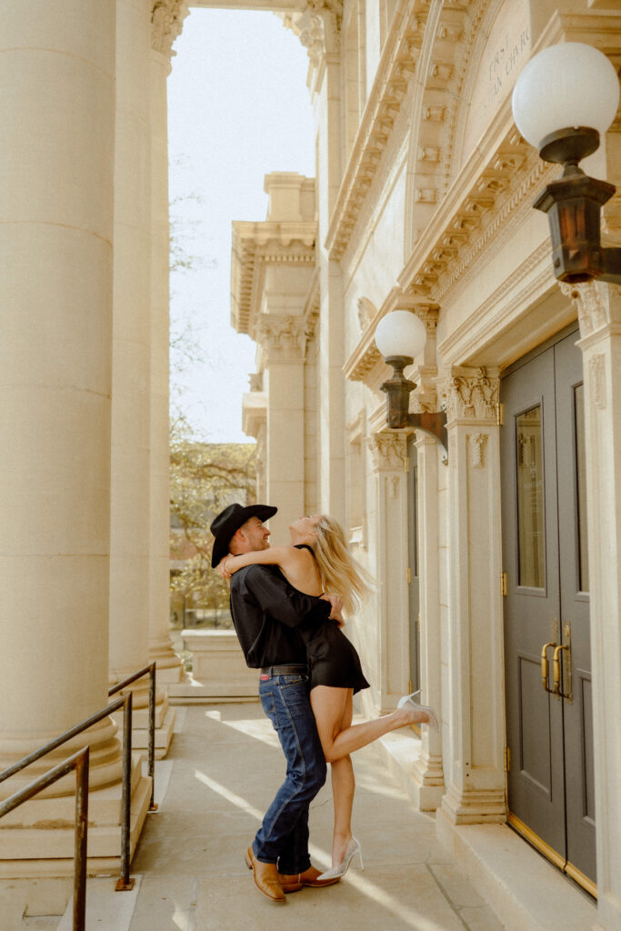 engagement session in downtown okc where he twirls her around