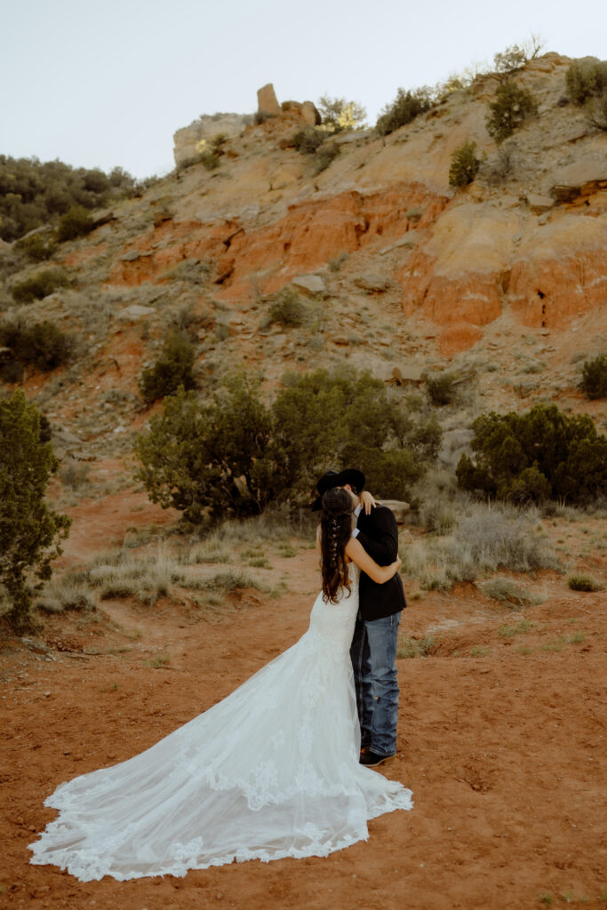 bride and groom share their first kiss at their texas elopement ceremony