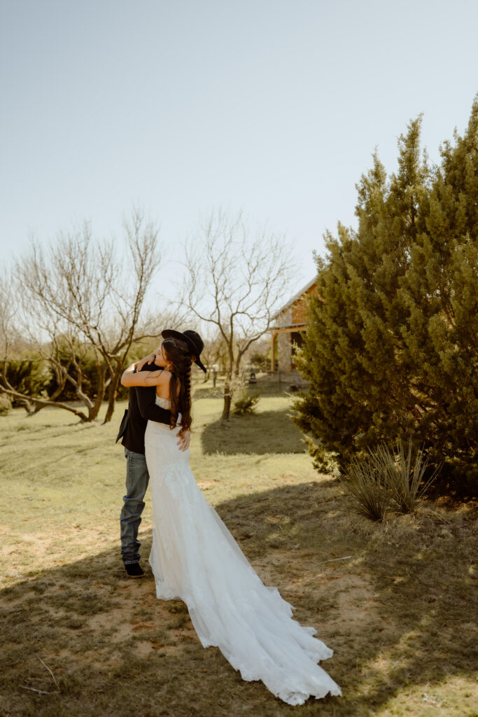 couple hugging during their first look outside the cabins near palo duro canyon state park