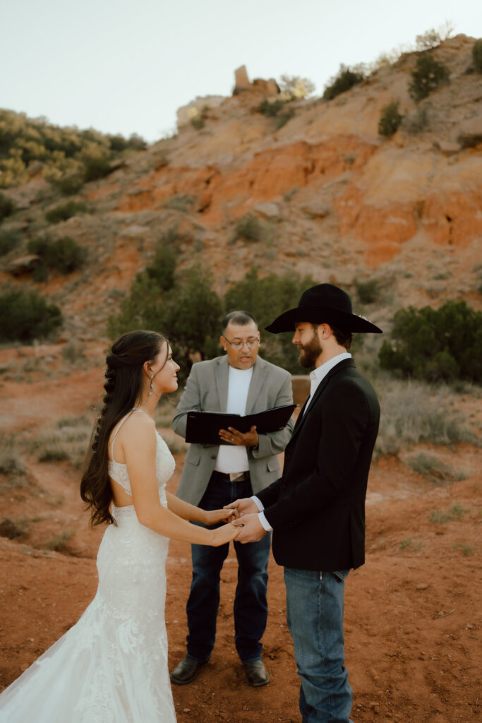 bride and groom exchange vows at palo duro canyon wedding ceremony