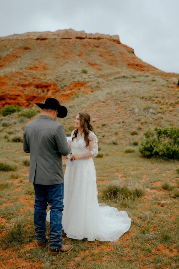 bride and groom laughing together during their private vows
