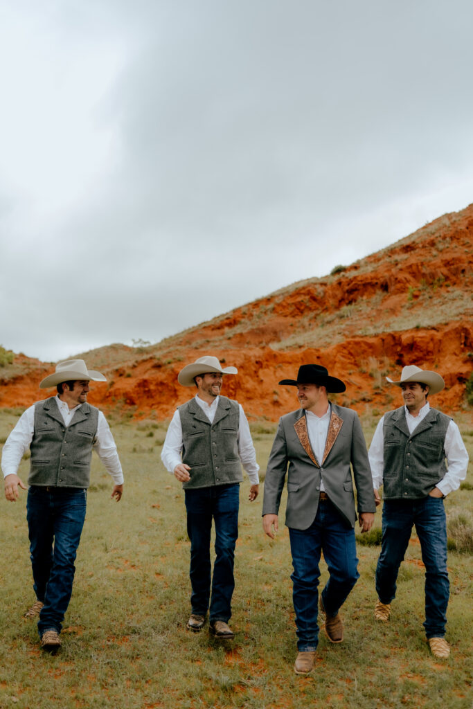 cowboy groom and groomsmen walking together