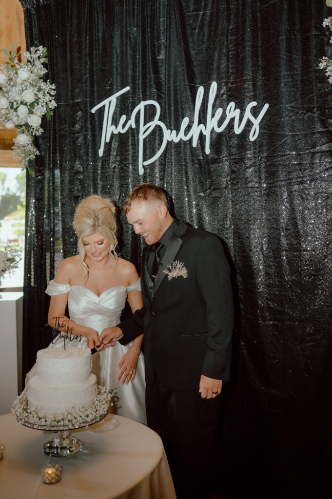 bride and groom cut cake
