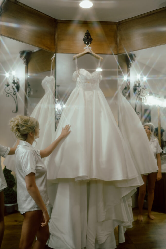bride admiring wedding dress