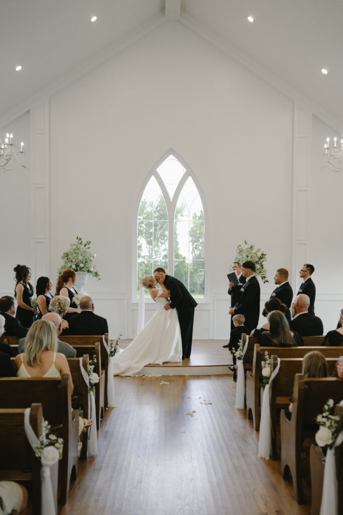 bride and groom kiss at chapel wedding ceremony at the springs venue