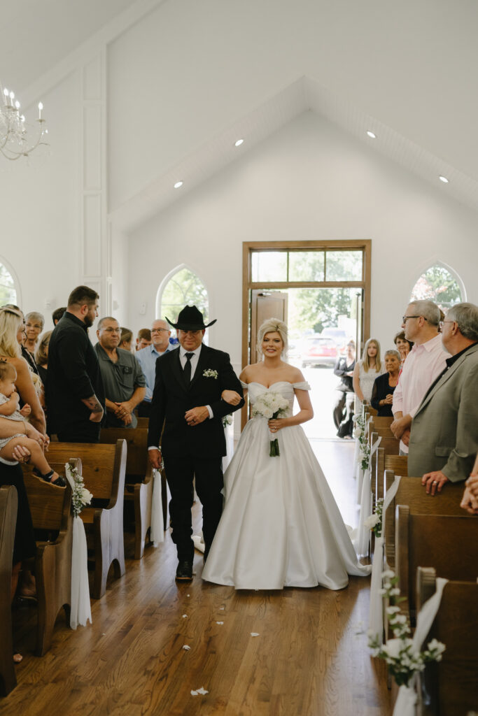 dad walks bride down the aisle at the chapel at the springs venue