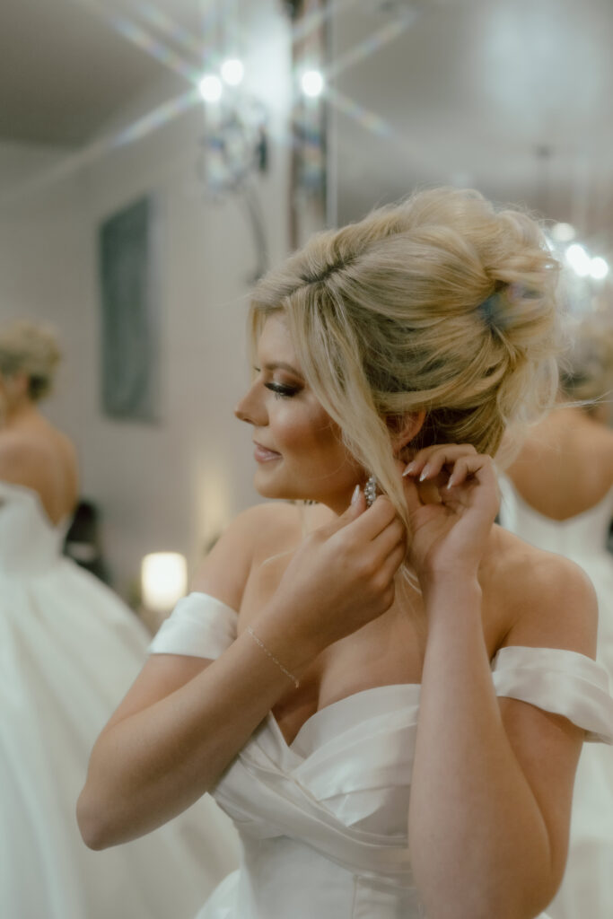 bride putting earrings in