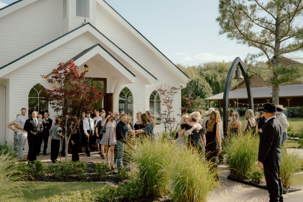 guests leaving the ceremony outside the chapel at the springs wedding venue