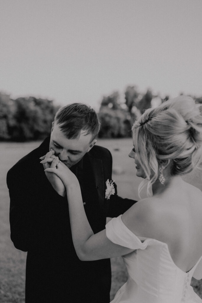 groom kisses brides hand