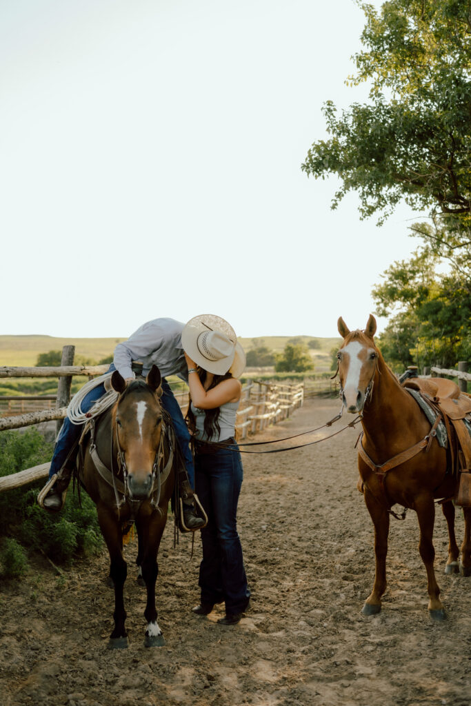 cowboy and cowgirl kissing during western couples photo
