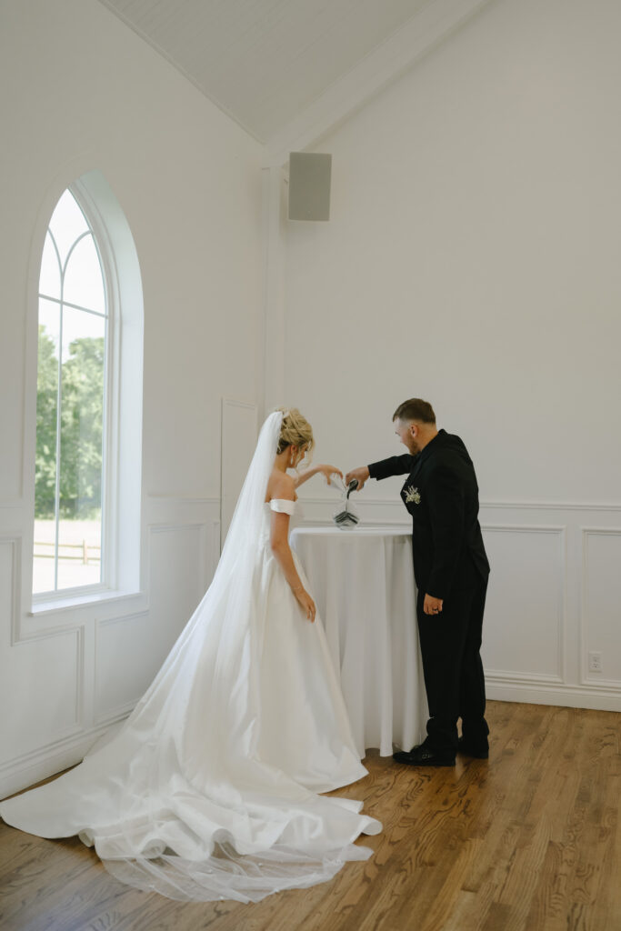 bride and groom pour sand at chapel wedding ceremony