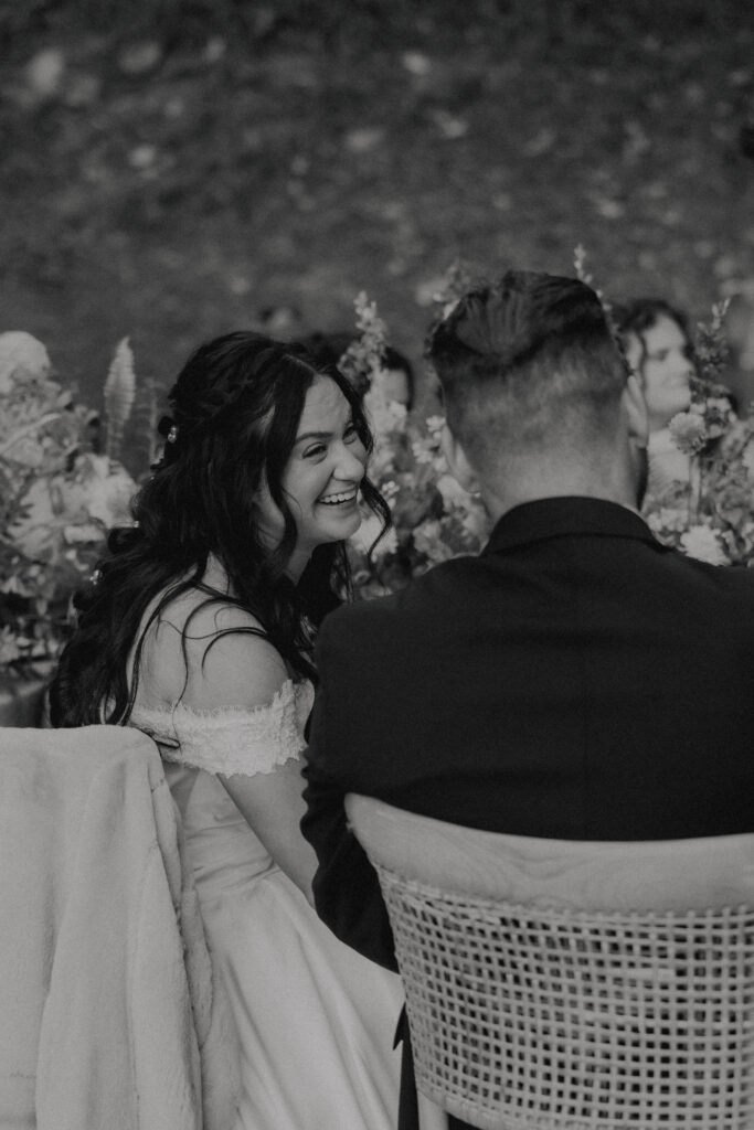 bride and groom laughing at wedding reception